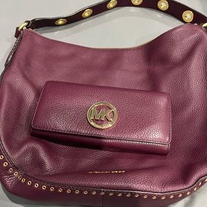 Michael Kors plum color bag with matching wallet.